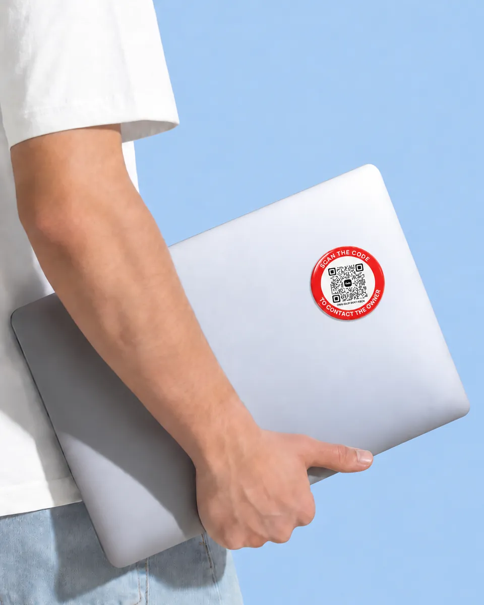 Someone carrying a laptop with a red OWN sticker on its lid